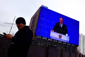 Vladimir Putin warned Russia could use nuclear weapons against the West during his state of the nation address, which was broadcast on giant screens in Moscow (Picture: Olga Maltseva/AFP via Getty Images)