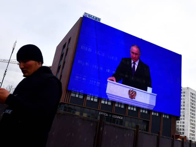 Vladimir Putin warned Russia could use nuclear weapons against the West during his state of the nation address, which was broadcast on giant screens in Moscow (Picture: Olga Maltseva/AFP via Getty Images)