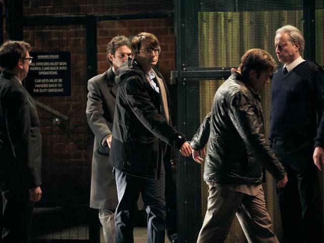 A recreation of the infamous shots of Dennis Nilsen (David Tennant) being lead out of Hornsey Police Station after admitting to murder.