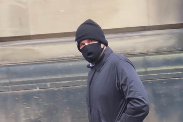 Conman Hay covers his face as he arrives at court to learn his fate.