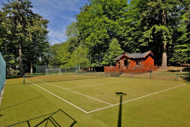 Full size sand based, Astro surfaced floodlit tennis court with decked pavilion.