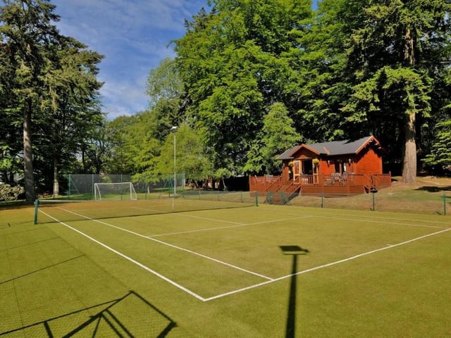 Full size sand based, Astro surfaced floodlit tennis court with decked pavilion.