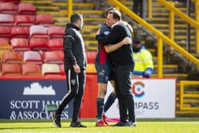 Ross County's Manager Malky Mackay hugs Jack Baldwin at full time.