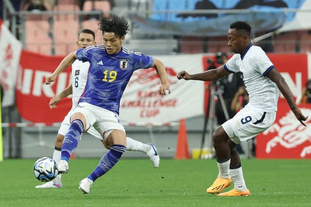 Japan's Reo Hatate is challenged by El Salvador's Brayan Gil during the 6-0 triumph at Toyota City.