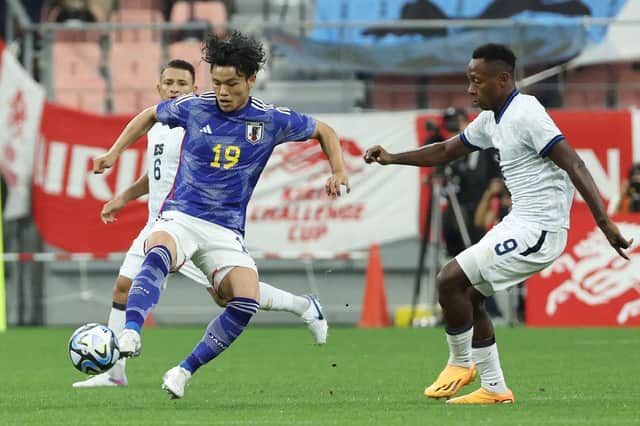 Japan's Reo Hatate is challenged by El Salvador's Brayan Gil during the 6-0 triumph at Toyota City.