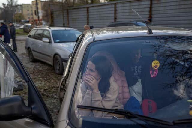 A Ukranian woman sits in a car with her family after they managed to flee from the Russian occupied territory of Kherson at the weekend.