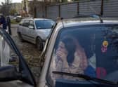 A Ukranian woman sits in a car with her family after they managed to flee from the Russian occupied territory of Kherson at the weekend.