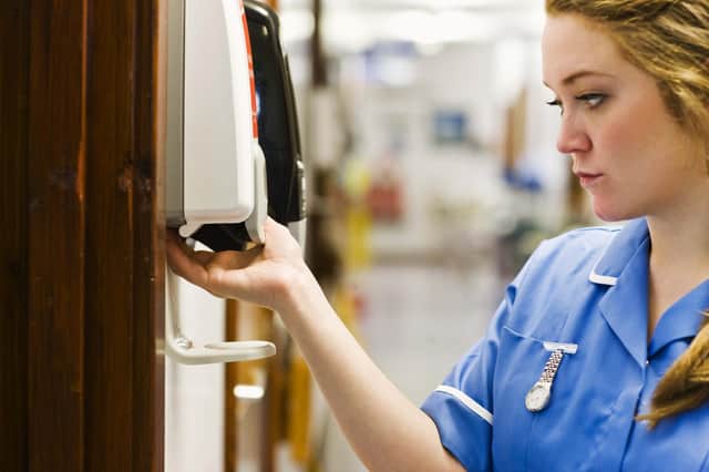A nurse uses hand gel in a hospital.