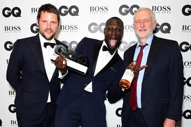 Stormzy with his Copper Dog Whiskey Solo Artist award with Gordon Smart (left) and Jeremy Corbyn during the GQ Men of the Year Awards 2017 held at the Tate Modern, London.