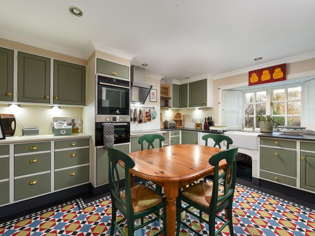 Interior: An entrance vestibule leads to a charming lounge with wood-burning stove and study area. There is a spacious kitchen, utility room, and a sunroom overlooking the garden. Contact Galbraith