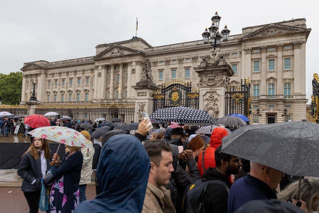 Members of the public gather outside Buckingham Palace, London, ahead of the arrival of the hearse carrying the coffin of Queen Elizabeth II. Picture date: Tuesday September 13, 2022.