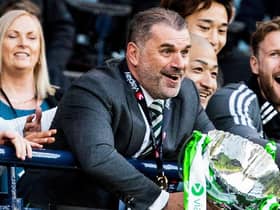 Celtic manager Ange Postecoglou lifts the Viaplay Cup trophy after a 2-1 win over Rangers.
