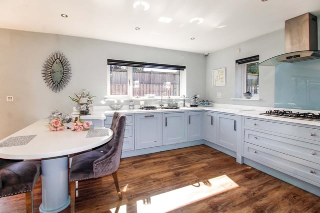 The kitchen features fitted appliances and lots of storage space, with a light, bright finish.