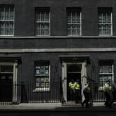 Police officers leave 10 Downing Street. Picture: AP Photo/Alastair Grant