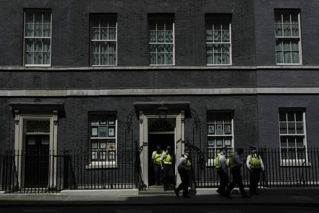 Police officers leave 10 Downing Street. Picture: AP Photo/Alastair Grant