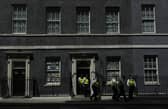 Police officers leave 10 Downing Street. Picture: AP Photo/Alastair Grant