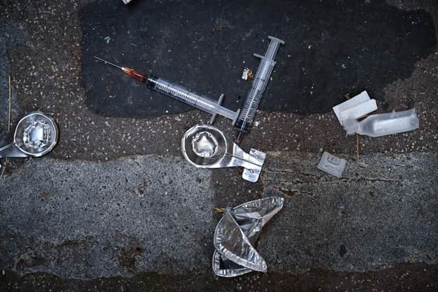 Needles are seen littering the pavement in a lane in Glasgow, Scotland, September 2020. Picture: Jeff J Mitchell/Getty Images