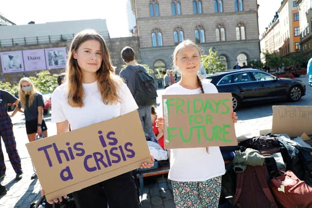 German climate activist Luisa Neubauer, left,and Swedish campaigner Greta Thunberg protest outside the Swedish Parliament during the weekly Fridays for Future demonstration in Stockholm earlier this month (Picture: Christine Olsson/TT News Agency/AFP via Getty Images)