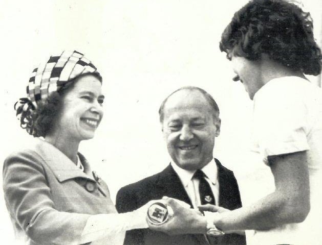 The Queen is handed the baton at the end of the 1970 Queen's Baton Relay.