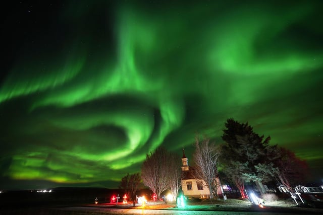 The northern lights over Villingaholtskirkja Church on the south coast of Iceland. Picture date: Sunday November 27, 2022. PA Photo. Photo credit should read: Owen Humphreys/PA Wire