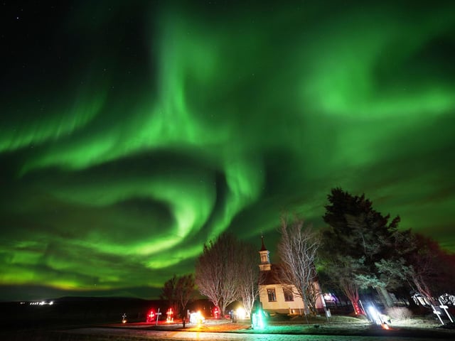 The northern lights over Villingaholtskirkja Church on the south coast of Iceland. Picture date: Sunday November 27, 2022. PA Photo. Photo credit should read: Owen Humphreys/PA Wire