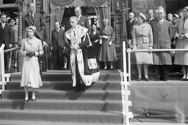 The Queen and Duke of Edinburgh leaving the Burgh Buildings in Falkirk accompanied by Provost R H Watson in 1955.