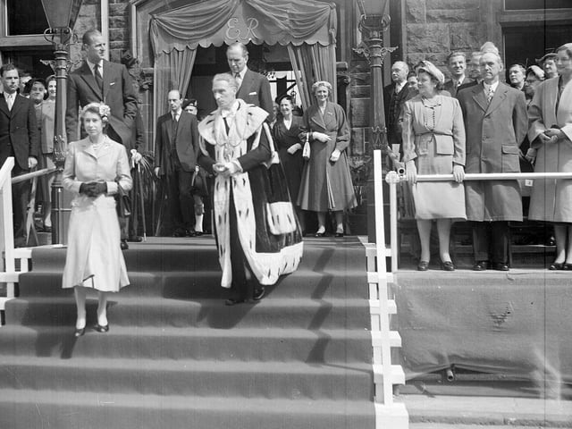 The Queen and Duke of Edinburgh leaving the Burgh Buildings in Falkirk accompanied by Provost R H Watson in 1955.