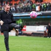 Celtic manager Brendan Rodgers kicks a ball back into the crowd at Tannadice - it was thrown on as apart of a protest by Celtic fans at ticket prices (Photo by Craig Foy / SNS Group)