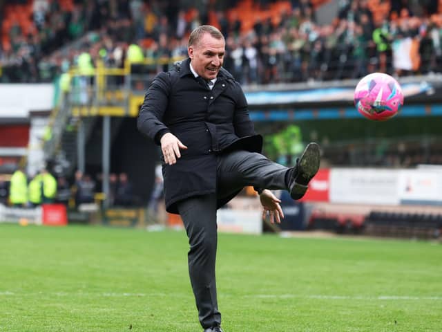 Celtic manager Brendan Rodgers kicks a ball back into the crowd at Tannadice - it was thrown on as apart of a protest by Celtic fans at ticket prices (Photo by Craig Foy / SNS Group)