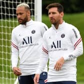 Paris Saint-Germain's Argentinian forward Lionel Messi and Paris Saint-Germain's Brazilian forward Neymar (L) take part in a training session at the Camp des Loges Paris Saint-Germain football club's training ground in Saint-Germain-en-Laye on August 19, 2021. (Photo by BERTRAND GUAY/AFP via Getty Images)