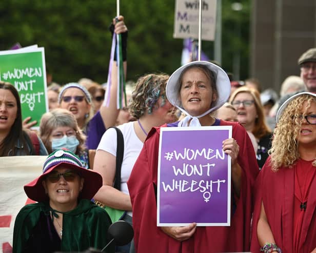 Women, including some dressed as characters from Margaret Atwood's The Handmaid's Tale, protest outside a court where Marion Millar was facing charges of threatening or abusive behaviour aggravated by prejudice relating to sexual orientation and transgender identity until the case was dropped (Picture: John Devlin)