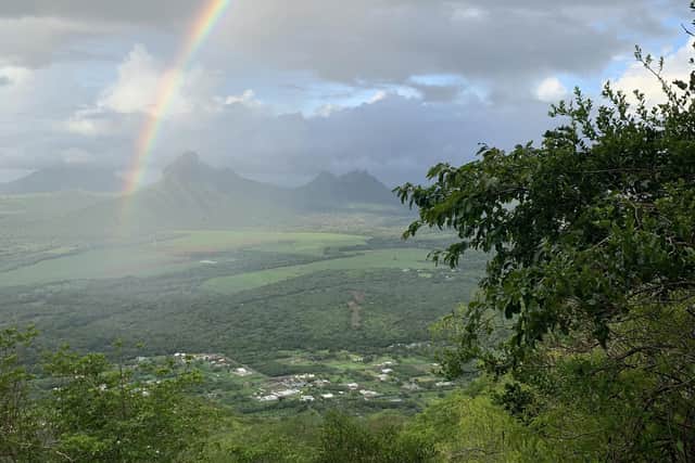 A rainbow appears over Tamarin, as seen from part-way up La Tourelle mountain. Pic: PA Photo/Ryan Hooper.
