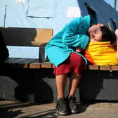 An evacuee girl sleeps outside railway station of western the Ukrainian city of Lviv, during Russia's military invasion launched on Ukraine. Photo by Aleksey Filippov / AFPGetty