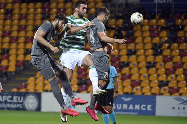 Riga's Herdi Prenga, left, and Marko Djurisic challenge for the ball with Celtic's Shane Duffy, center, during the clubs' Europa League third qualifying round tie at Skonto stadium. (AP Photo/Roman Koksarov)