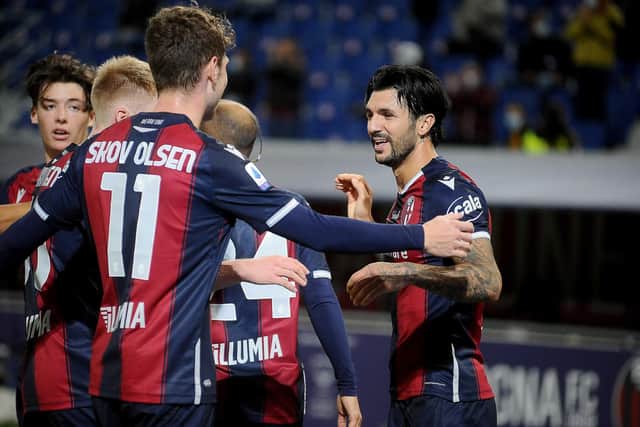 Aaron Hickey, left, celebrates with his new Bologna team-mates after Roberto Soriano's second goal.