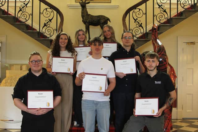 From left to right, [back row] Paige Reid, Martha Morton, [middle row] Caitlyn Constantine, Aryn Folkard, [front row] Aarryn Dunn, Bobby Clark, and Jon Smith.