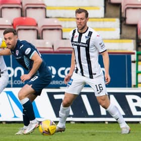 Raith's Lewis Vaughan (centre) is challenged by Euan Murray of Dunfermline.