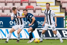 Raith's Lewis Vaughan (centre) is challenged by Euan Murray of Dunfermline.