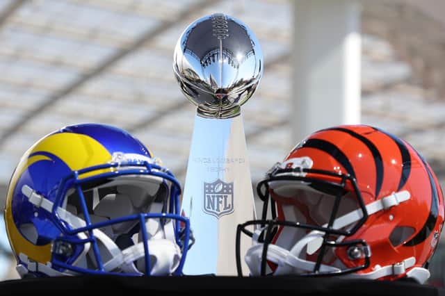 Helmets of the Los Angeles Rams and Cincinnati Bengals sit in front of the Lombardi Trophy.  (Photo by Rob Carr/Getty Images)