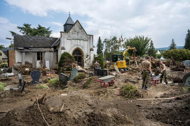 German soldiers work to clean up a flood-damaged cemetery in Bad Neuenahr-Ahreweiler (Picture: Thomas Lohnes/Getty Images)