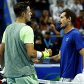 Jakub Mensik prepares to shake hands with Andy Murray after his victory at the Qatar Open. (Photo by KARIM JAAFAR/AFP via Getty Images)
