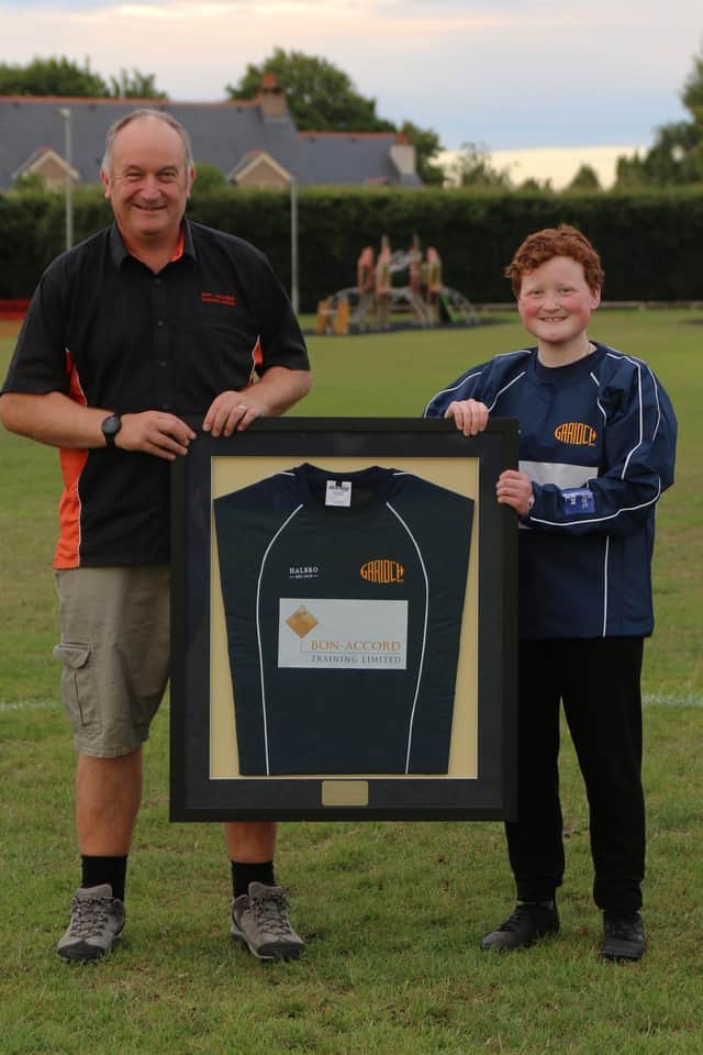 Bon Accord Training’s Operations Director, Iain Sanderson, received a framed training top from Katie Henderson of Garioch Rugby Girls Team, in recognition of their ongoing sponsorship.