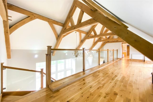 The landing has large French oak timber ceiling beams overhead.