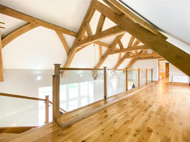 The landing has large French oak timber ceiling beams overhead.