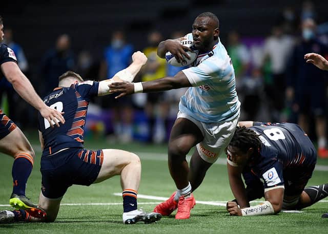 Edinburgh's centre George Taylor (L) fights for the ball with Racing92's French flanker Jordan Joseph (C) during the match at the U Arena in Nanterre, near Paris on April 4, 2021. (Photo by FRANCK FIFE/AFP via Getty Images)