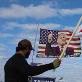 Supporters fly a flag featuring Donald Trump near his Mar-a-Lago home after the former president called on his supporters to protest a possible arrest and indictment. Picture: Getty Images