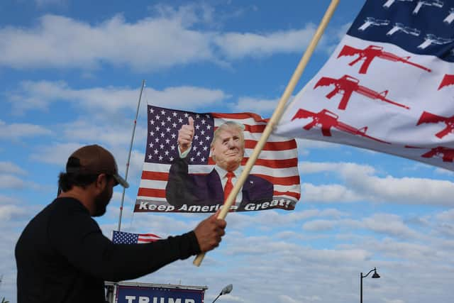 Supporters fly a flag featuring Donald Trump near his Mar-a-Lago home after the former president called on his supporters to protest a possible arrest and indictment. Picture: Getty Images