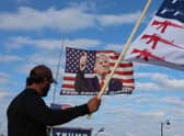 Supporters fly a flag featuring Donald Trump near his Mar-a-Lago home after the former president called on his supporters to protest a possible arrest and indictment. Picture: Getty Images
