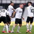Martyn Waghorn of Derby County celebrates with Colin Kazim-Richards and Tom Lawrence after scoring their side's first goal during the Sky Bet Championship match between Derby County and Sheffield Wednesday at Pride Park Stadium on May 08, 2021 in Derby, England. (Photo by Alex Pantling/Getty Images)