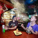 Customers smoke marijuana at the New Amsterdam Cafe in Vancouver, British Columbia, Canada, where Marijuana has been legal since 2018.